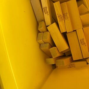 Jenga Wooden Blocks in Bright Yellow Container